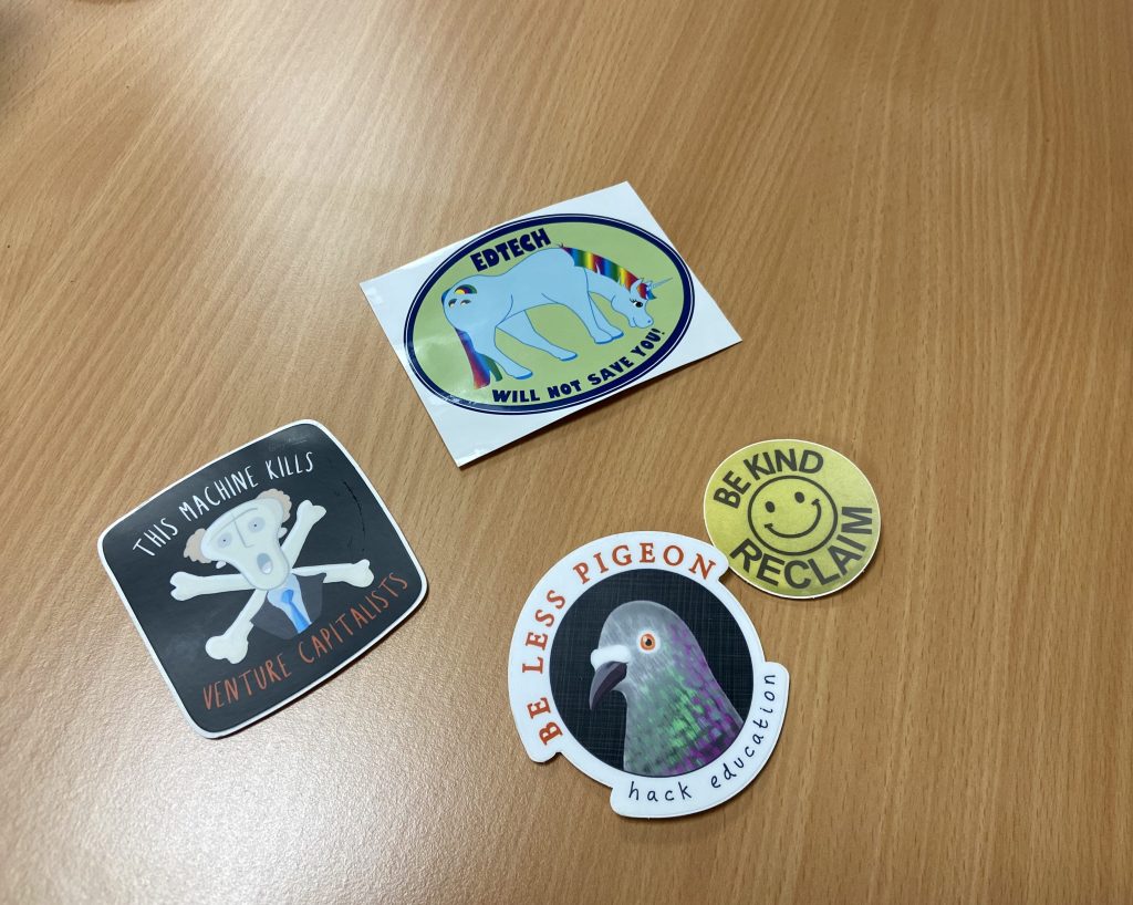 Collection of ed tech critical stickers on desktop